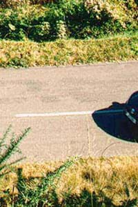 travelling by car on the road with green grass either side 