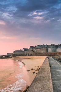 view of st malo walls in brittany with pink sky